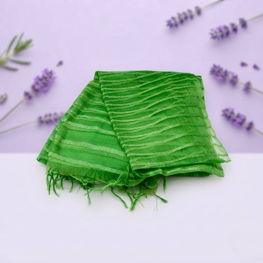 A  vibrant green striped chiffon or sheer dupatta scarf with tasseled edges.